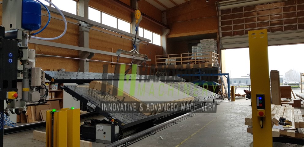 Insulated wall element being handled on timber frame production machine